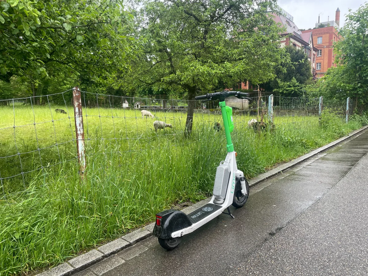 Ein E-Trottinett der Marke Lime steht am Strassenrand.